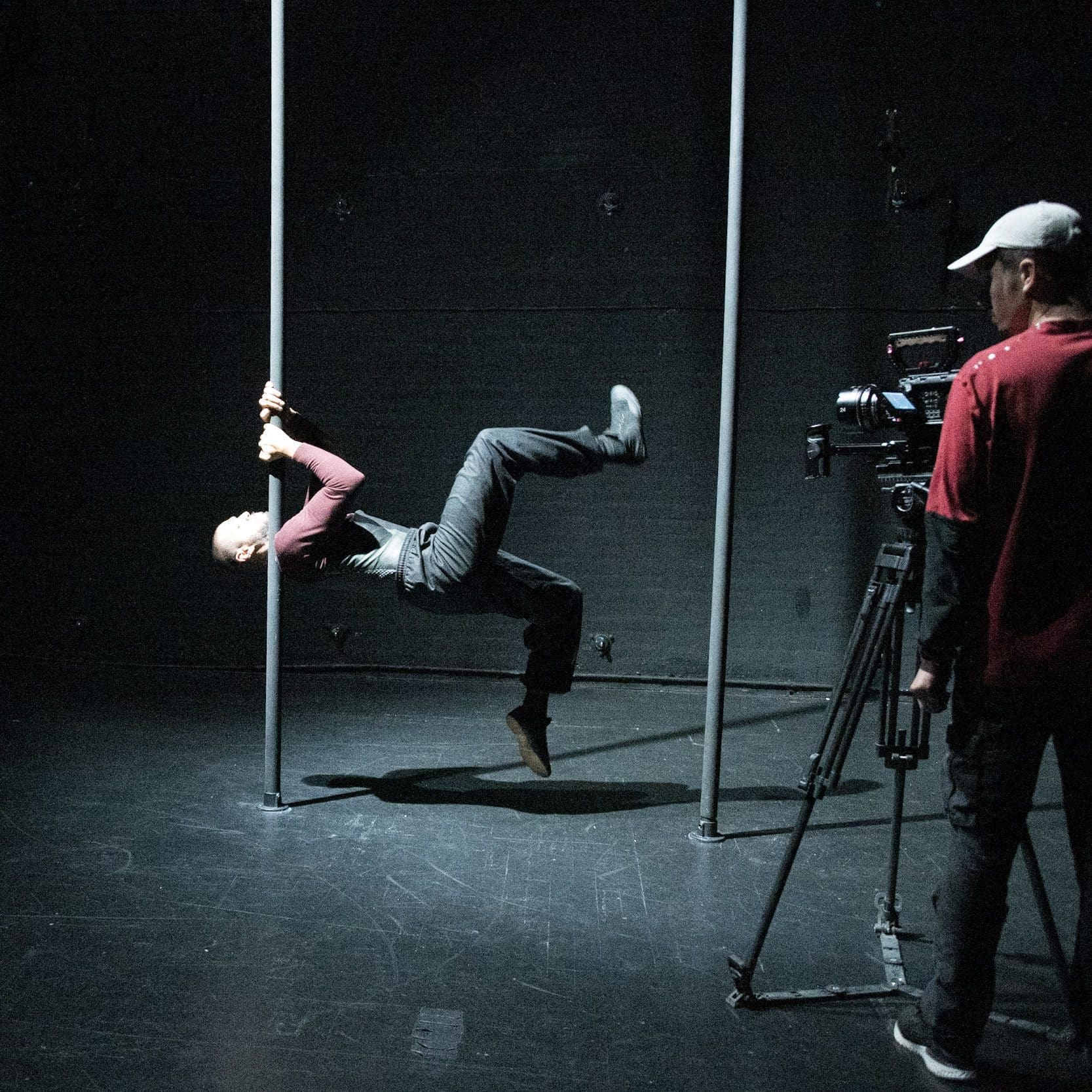 A man is filmed about to balance on a chinese pole