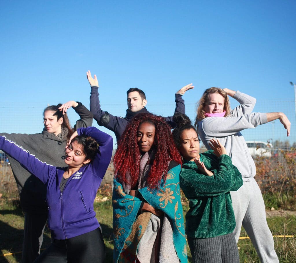 A group of diverse young people vogue for the camera