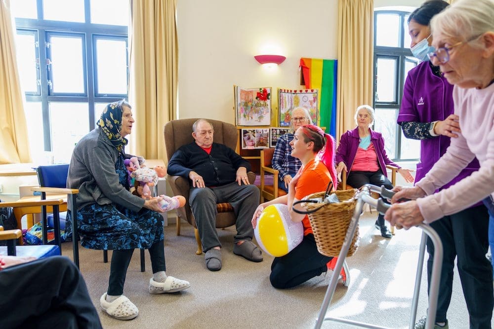 people trying out different circus activities like juggling and ball throwing in a care home